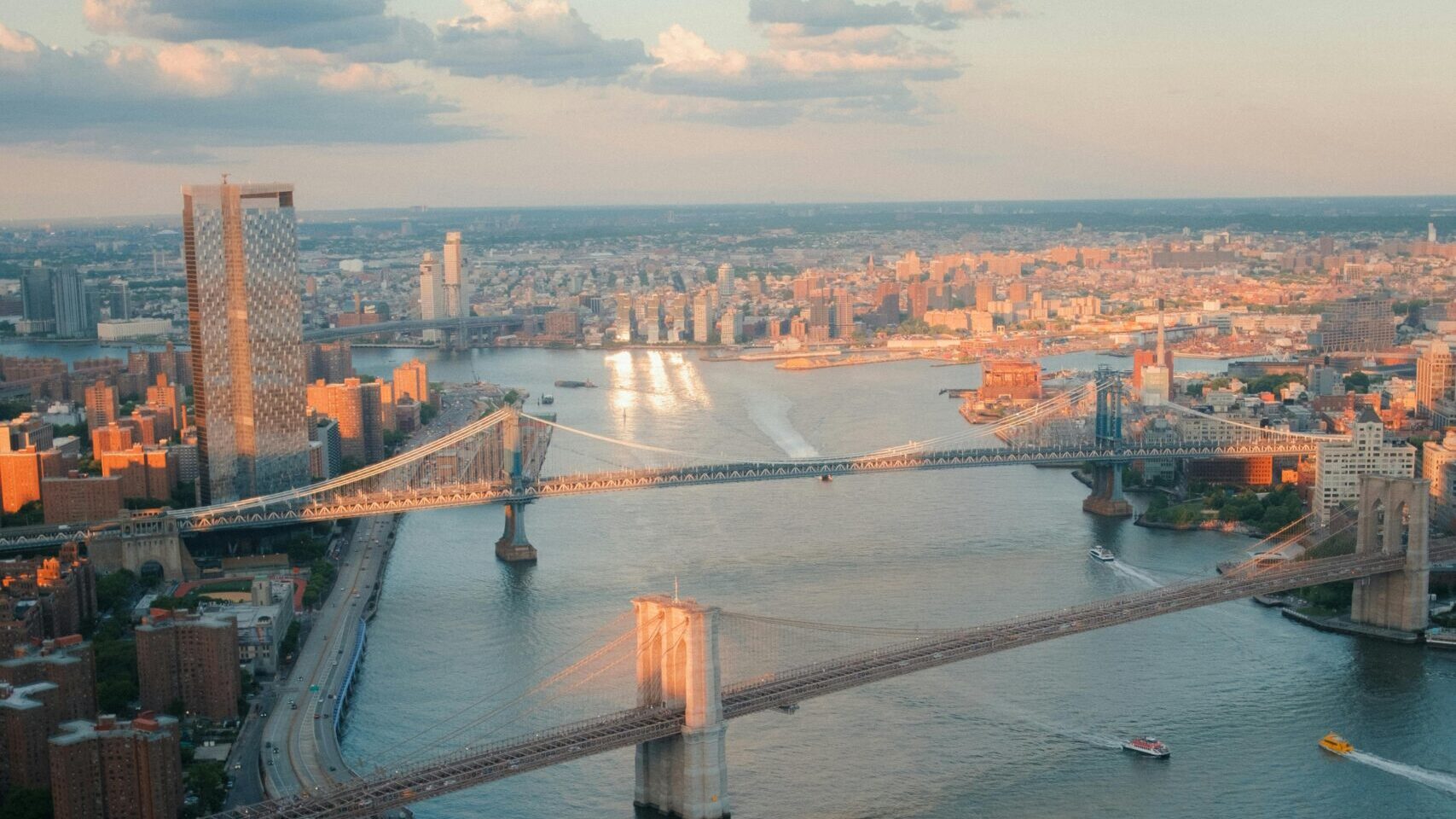 Photo by henry: https://www.pexels.com/photo/sea-coast-of-new-york-with-brooklyn-bridge-at-sunset-27498575/